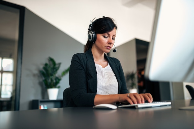 Female helpline operator working.