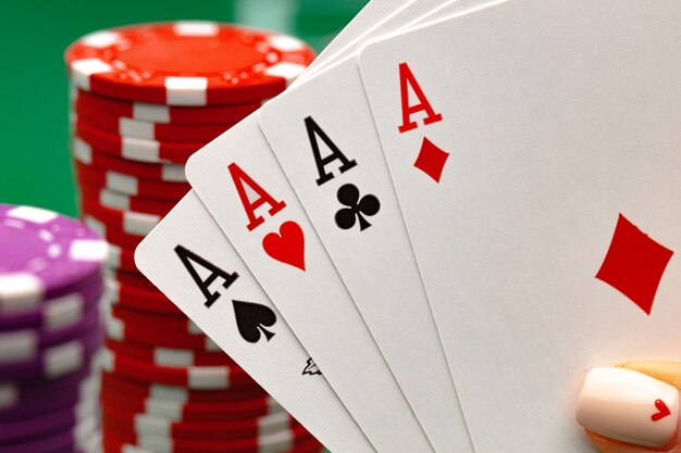 Female holding playing cards playing poker at green table