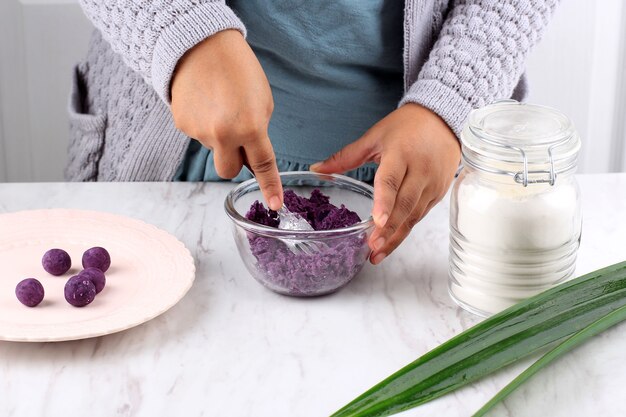 Female Indonesian Hand Mashed Steamed Purple Sweet Potato Process Making Biji Salak Ubi Ungu