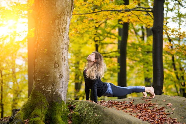 Female is practicing yoga and doing asana