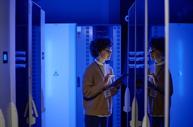 Female it engineer working in server room