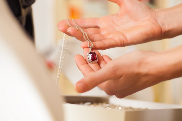 Female jeweler presenting jewelry