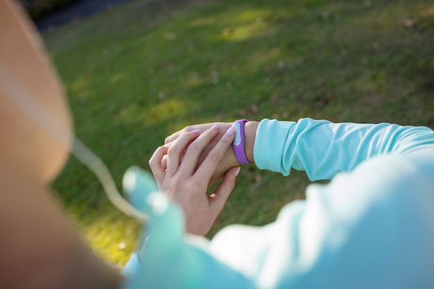 Female jogger checking her fitness band