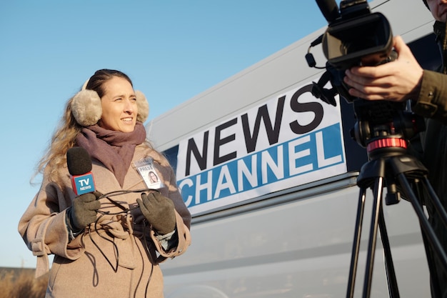 female journalist looking at operator