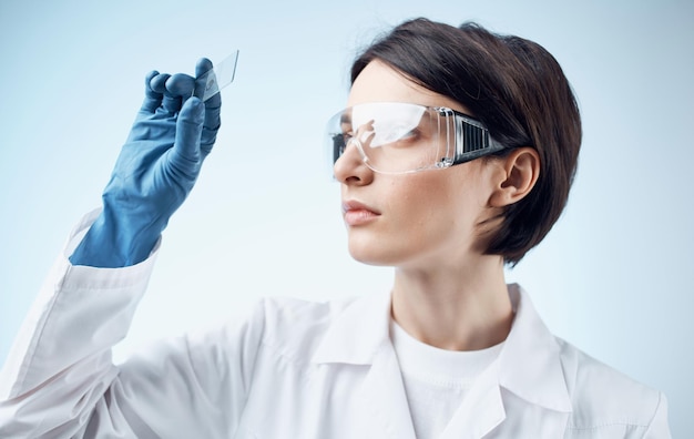 Female laboratory assistant in a white coat analysis diagnostics biology high quality photo