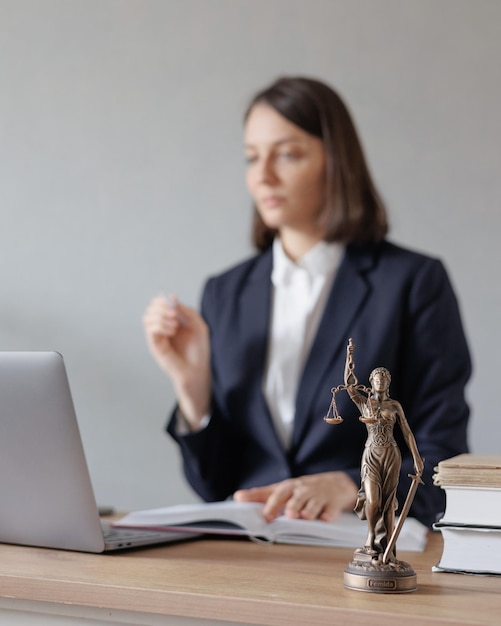 Female lawyer conducts an online consultation from a laptop via video link for a client work in a