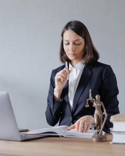 Female lawyer conducts an online consultation from a laptop via video link for a client work in a