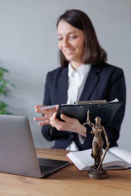 Female lawyer conducts an online consultation from a laptop via video link for a client work in a