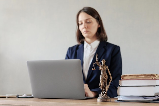 Female lawyer conducts an online consultation from a laptop via video link for a client work in a