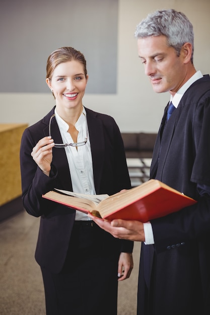 Female lawyer standing by male colleague