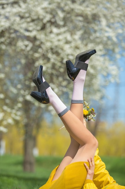 Female legs over blooming tree background