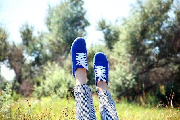 Female legs in colorful sneakers outdoors