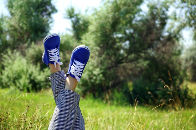 Female legs in colorful sneakers outdoors