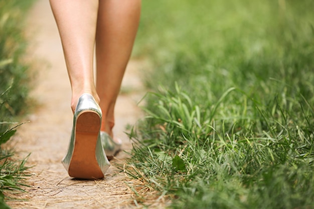 Female legs on green grass