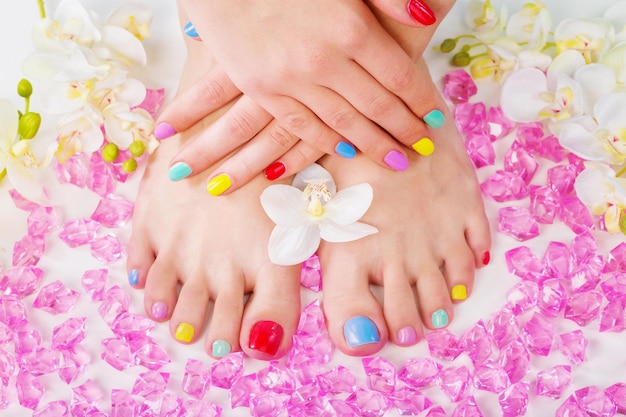 Female legs and hands with manicure and flowers