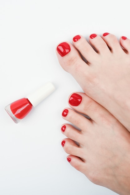 Female legs and red nail polish