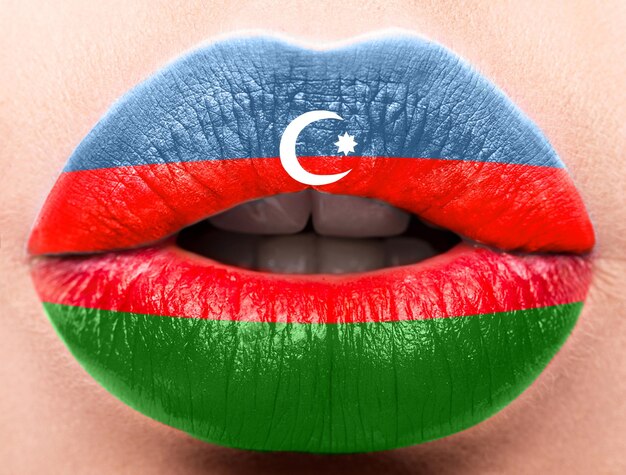 Female lips close up with a picture flag of Azerbaijan Blue red green