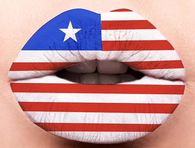 Photo female lips close up with a picture of the flag of liberia white red blue