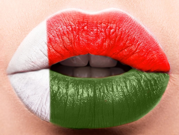 Female lips close up with a picture of the flag of Madagascar red green white