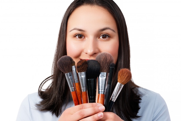 A female makeup artist with a set of makeup brushes