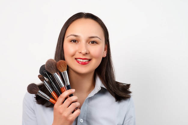 A female makeup artist with a set of makeup brushes