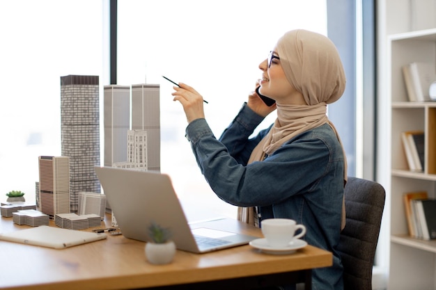 Female making phone call while running project from office