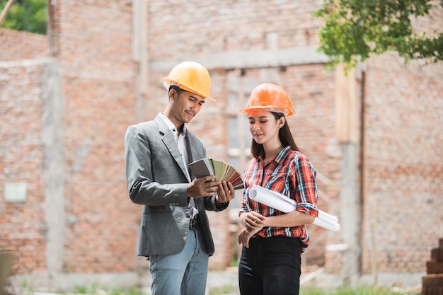 Female and male architect picking paint color