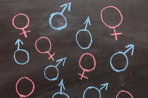 Female and male gender symbol on a chalk Board. Background