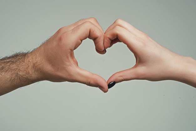 Female and male hands in form of heart hands in shape of love heart hearts froms hands love concept