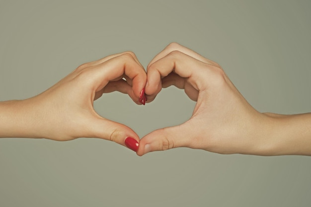 Female and male hands in form of heart hands in shape of love heart hearts froms hands love concept