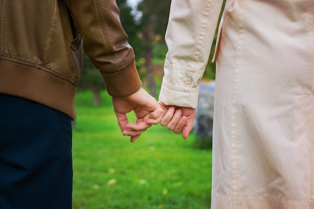 female and male hands holding hands