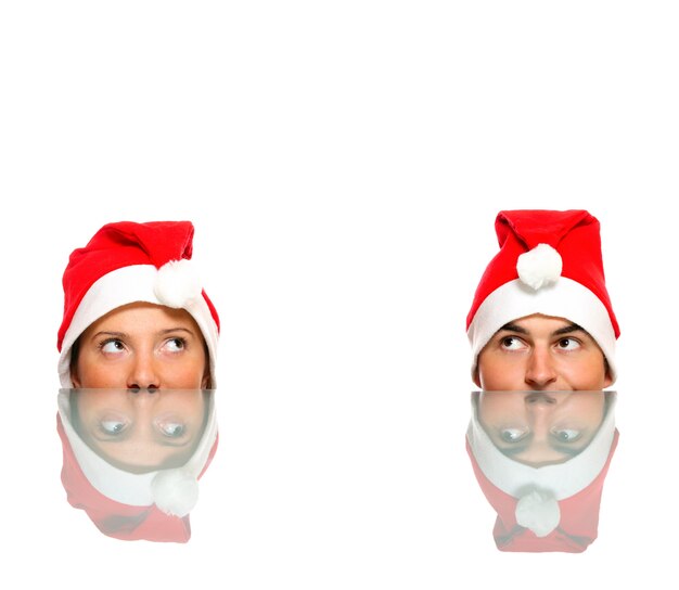 A  female and male Santas and their reflections over white