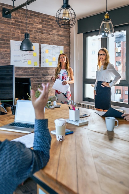 Female manager answering questions in a work meeting