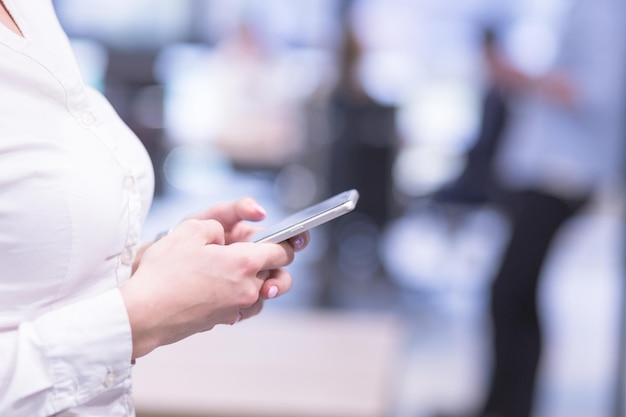 female manager using cell telephone in startup office interior