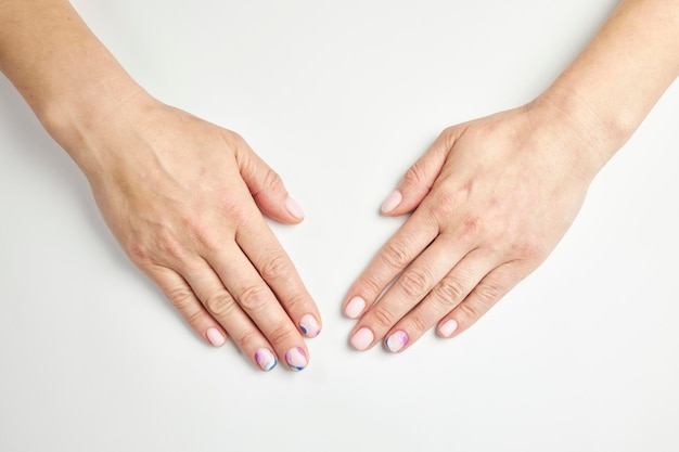 female manicure on a white background. nail. Women's hands with a beautiful manicure.