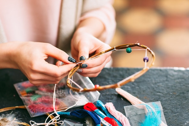 Female master creating new dreamcatcher