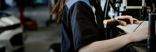 Female mechanic analysing the report