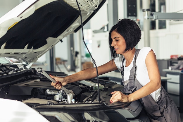 Female mechanic working at service