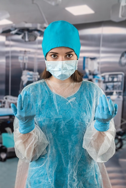 Female medical worker in blue uniform alone in recovery room in hospital with stethoscope