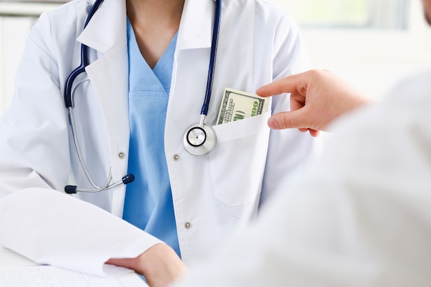 Female medicine doctor chest with bunch of hundred dollars bankn