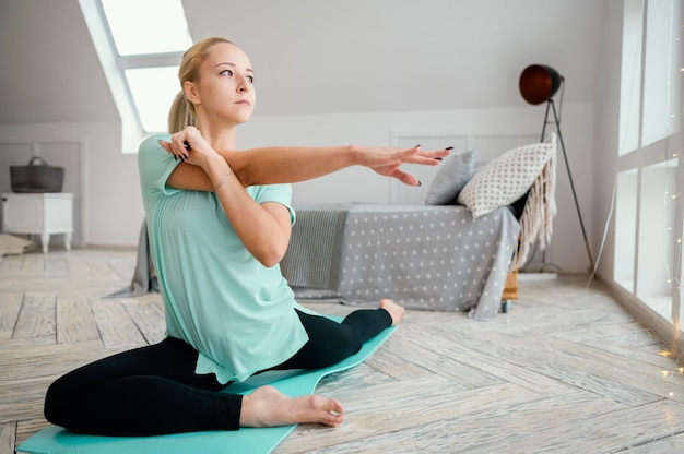 Female meditating on mat