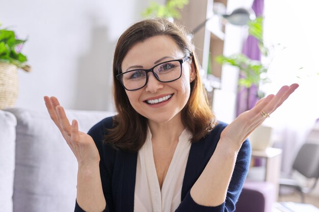 Female mentor, tutor, teacher looking at webcam of laptop, closeup face. Video conference, online lesson, teacher teaching remotely. Technology, education, school concept