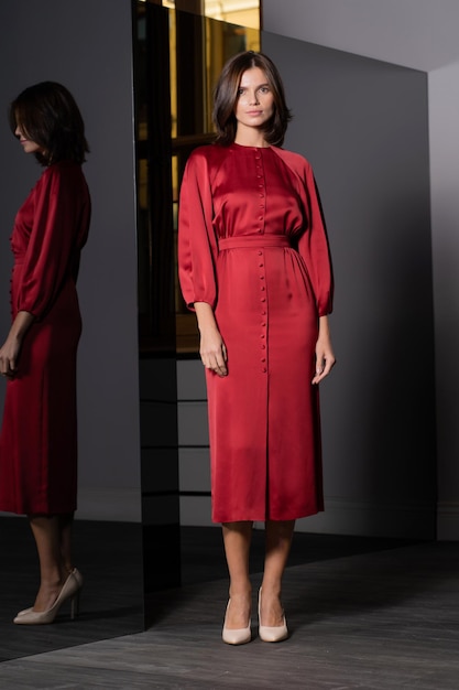 A female model demonstrates a modern dress in the salon A fashionable women's clothing store