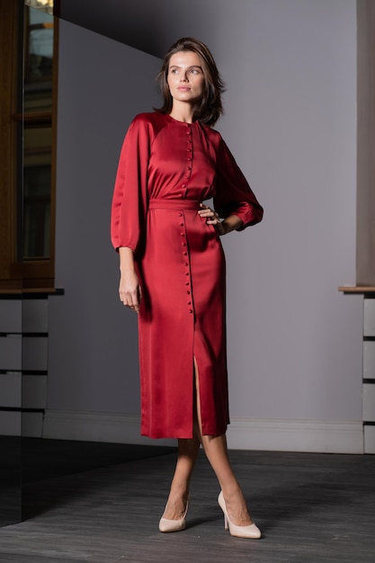 A female model demonstrates a modern dress in the salon A fashionable women's clothing store