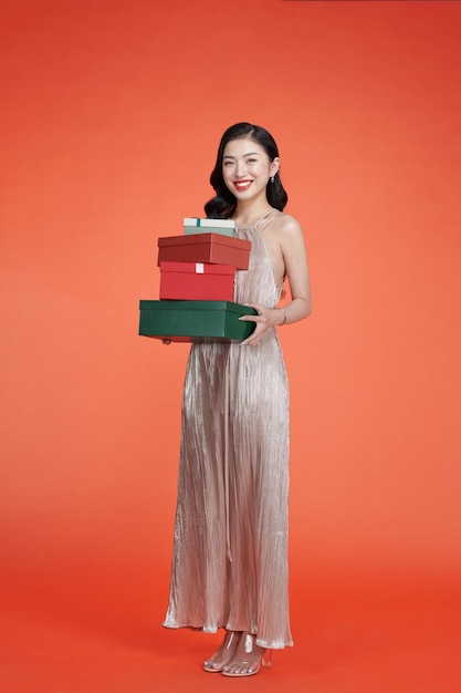 Female model wear glamorous dress keeps gifts