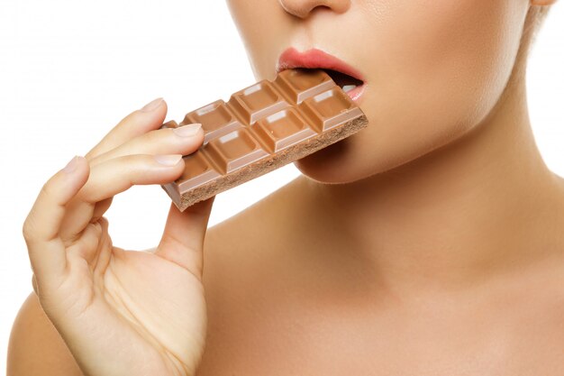 Female mouth and chocolate bar