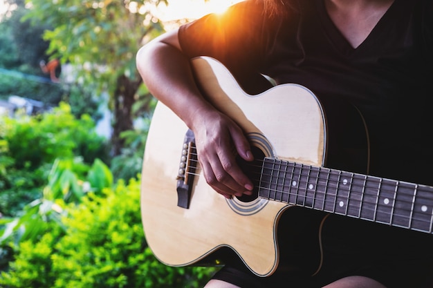 Female musician playing classical guitar