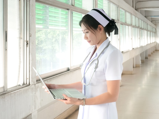 Female nurse is working with notebook