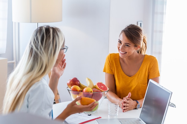 Female nutritionist giving consultation to patient