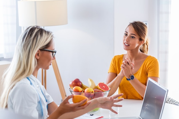 female nutritionist giving consultation to patient